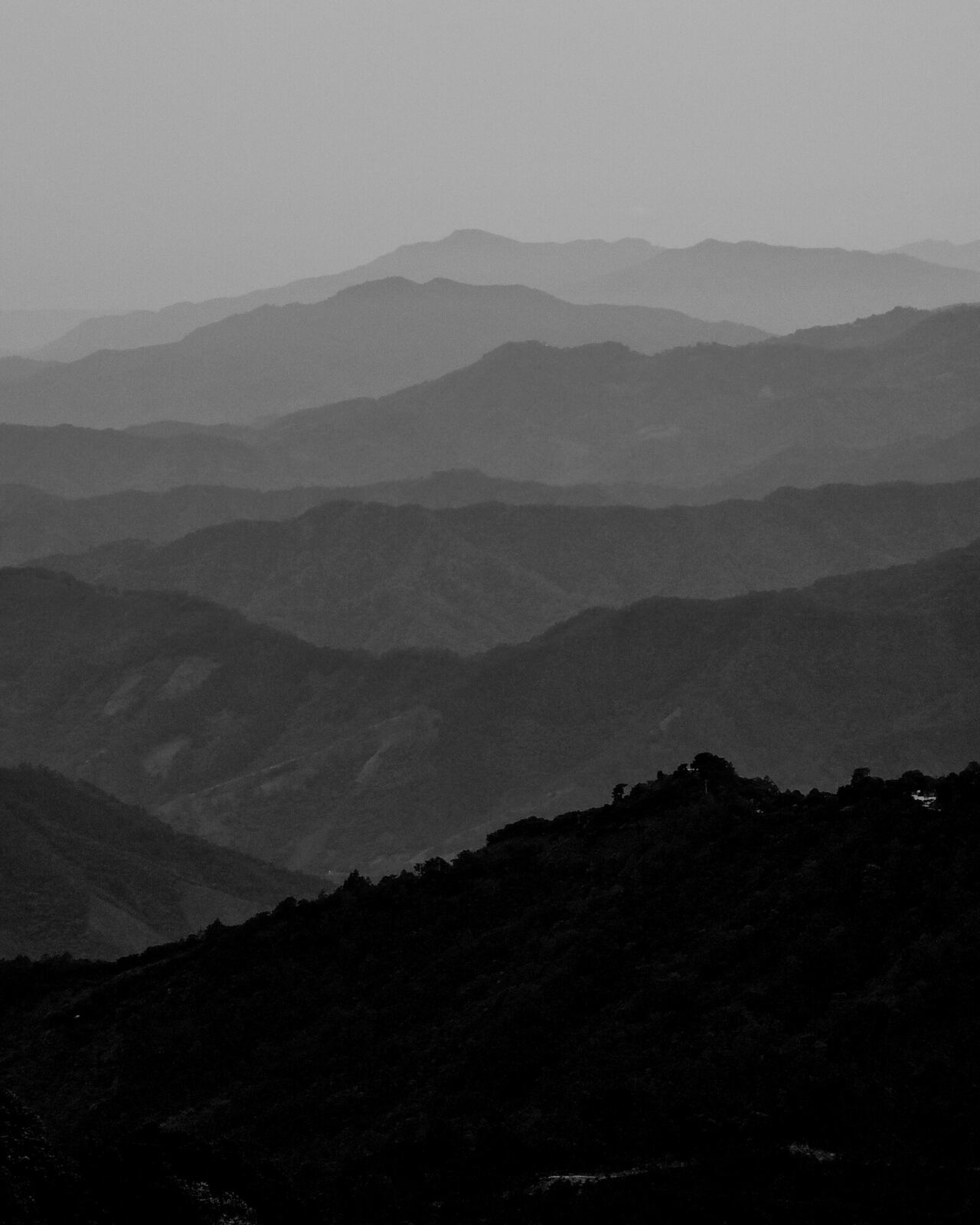 Capas de sierras en blanco y negro perdiéndose en la bruma